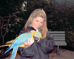 Laure Monaco Torelli holding a parrot