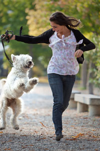Woman running happily with her dog